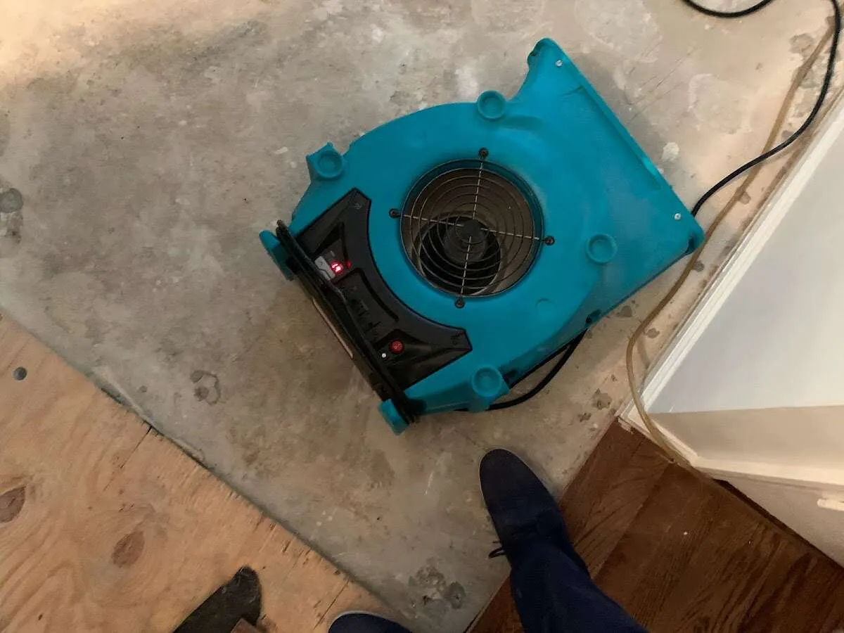 Air mover drying subfloor during Commercial Water Damage Restoration in Mebane